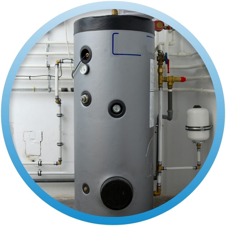 Large vertical hot water storage tank with pressure gauge.