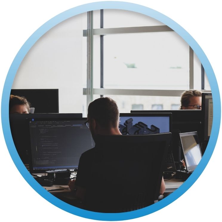 People working on computers in a modern office space.