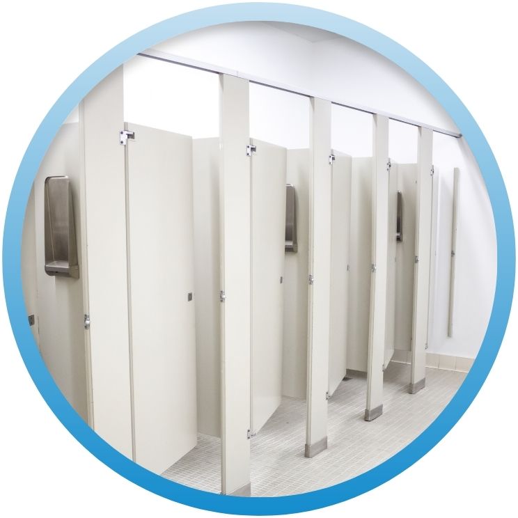 Row of clean white commercial restroom toilet stalls.