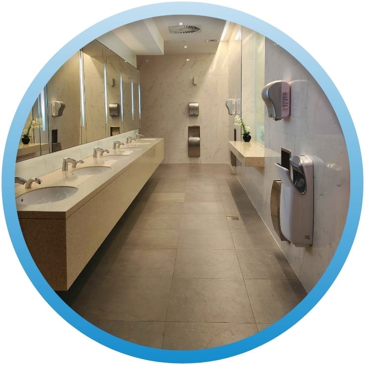 Modern commercial restroom with multiple sinks and mirrors.