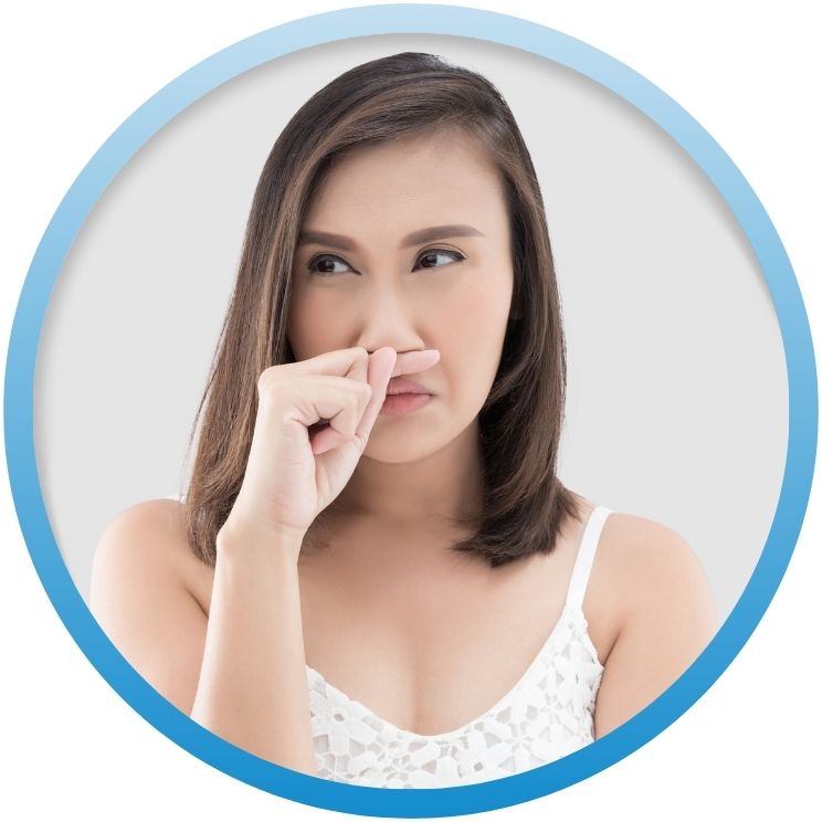 Woman pinching her nose due to an unpleasant odor.