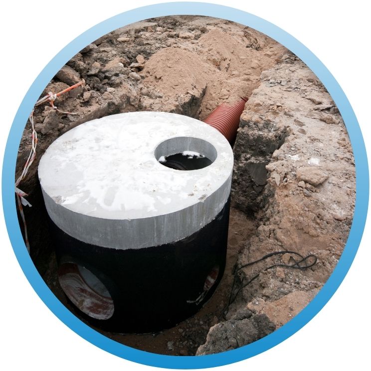 Pre-cast concrete dry well or catch basin connected to a corrugated pipe.