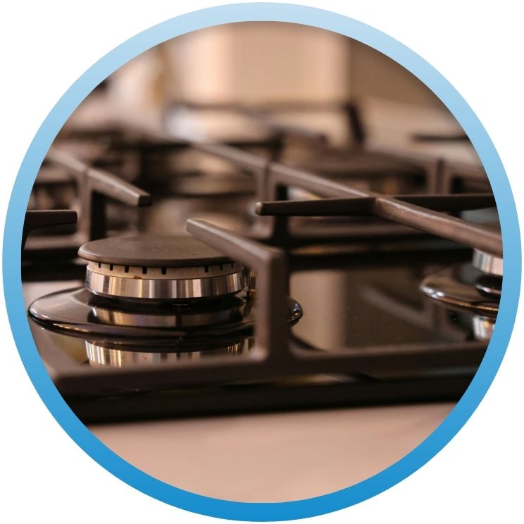 Close-up of a modern black gas stovetop burner.