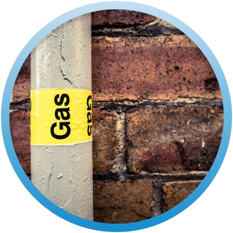 Exterior gas pipe with a yellow "Gas" identification label.