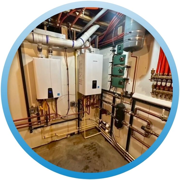 Dual tankless water heater installation with red PEX piping.