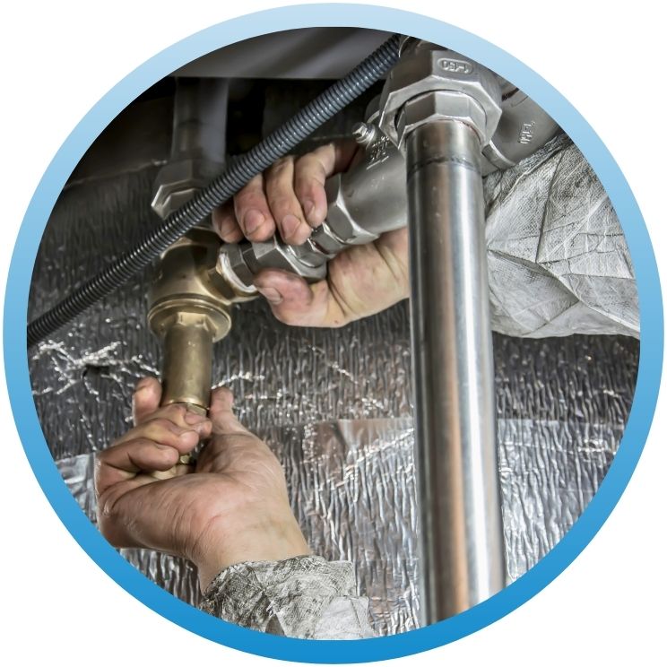 Hands tightening a heavy-duty industrial pipe fitting.