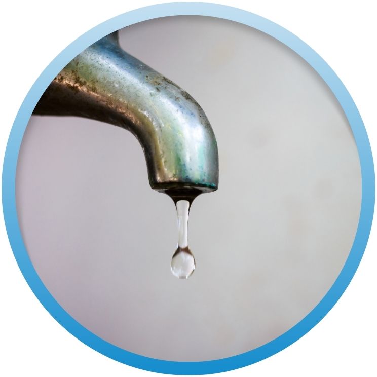 Single water droplet falling from a chrome faucet.