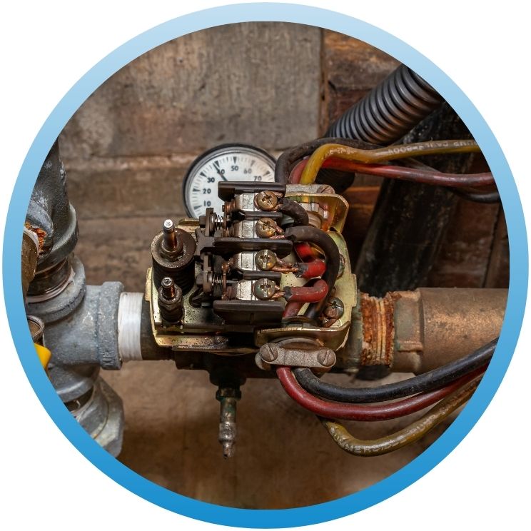 Close-up of an electrical pressure switch on a well pump.