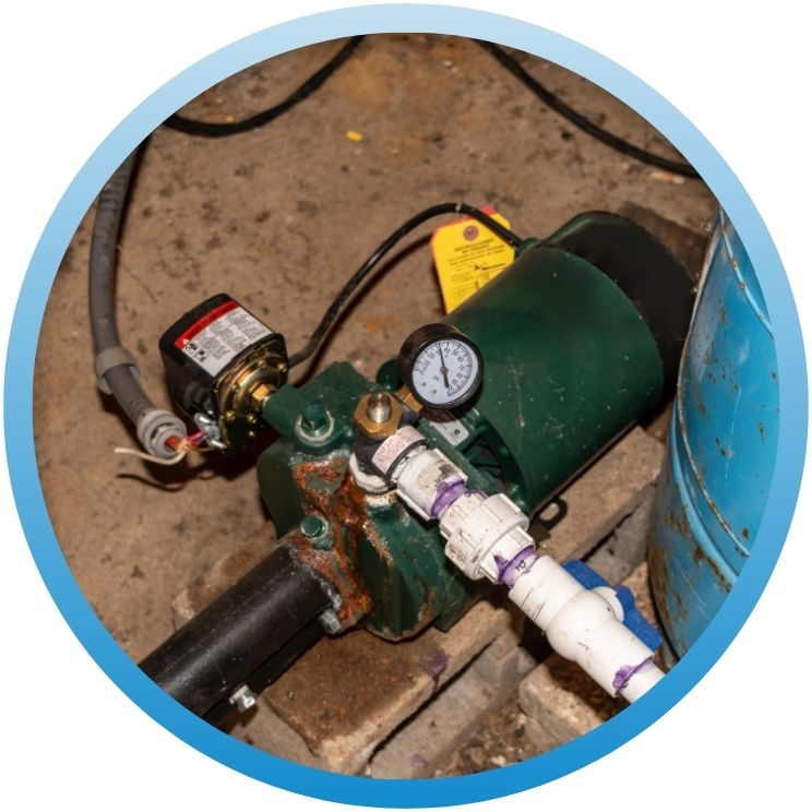 Green shallow well jet pump with pressure gauge and piping.