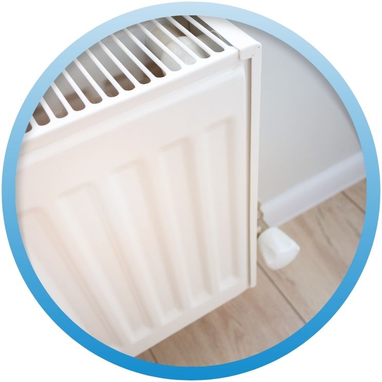 Close-up of a white wall-mounted hydronic radiator panel.