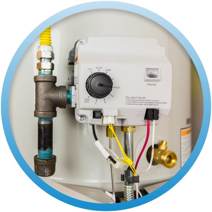 Close-up of a gas water heater's pilot control valve.